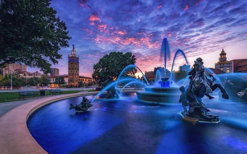 A photo of a Kansas City Royal Blue fountain during a sunset, by Johnathan Tasler
