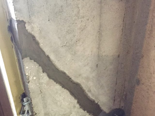 A large basement crack filled with apoxy in preparation for applying carbon fiber sheet